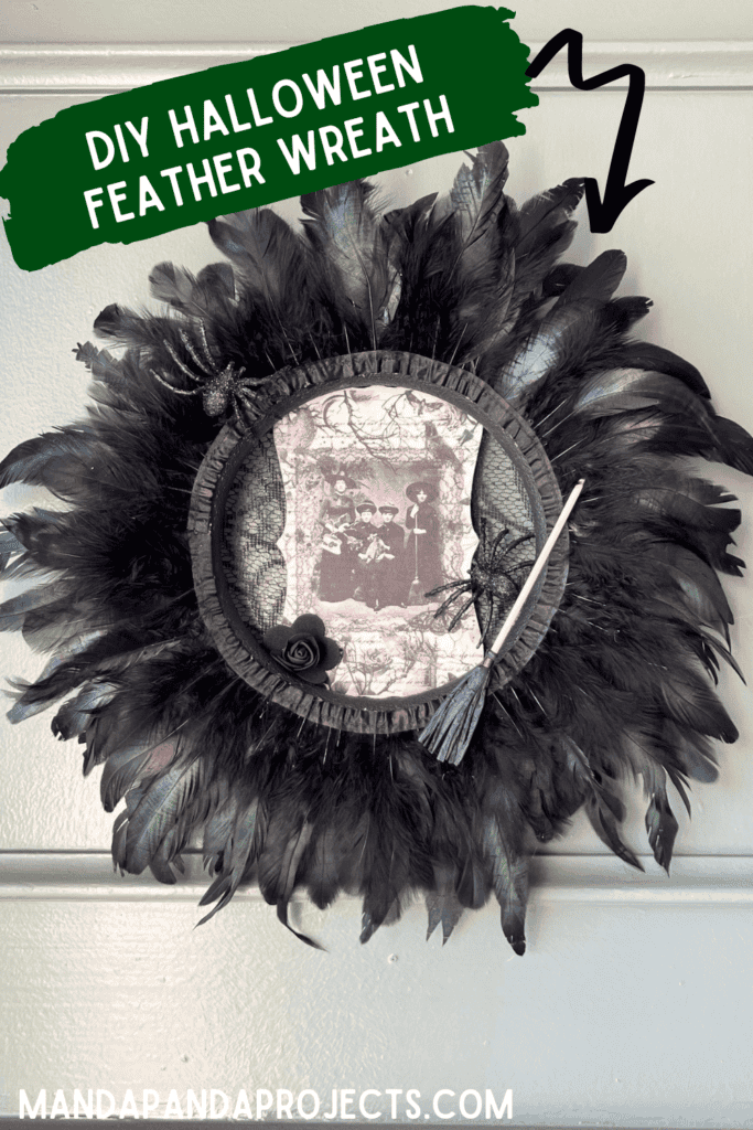 Dollar Tree styrofoam wreath form with black feather trim around the outside, vintage witches rice paper sign in the center, and embellished with faux spiders, mini broomstick, and a black rose for DIY Halloween crafts and decor.