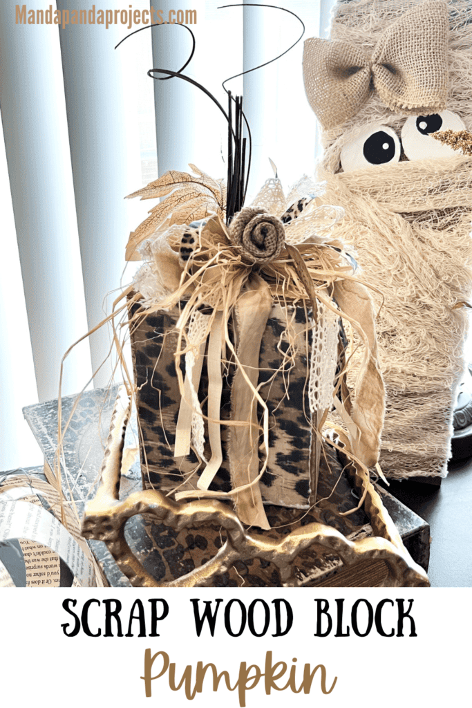 Scrap Wood Block Chunky Neutral Pumpkin with gold, leopard print, hymnal sheet, and a messy bow with a burlap flower and fall leaf embellishment.