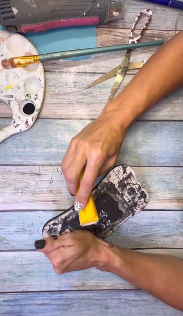 Sanding off the excess rice paper from the plaque.