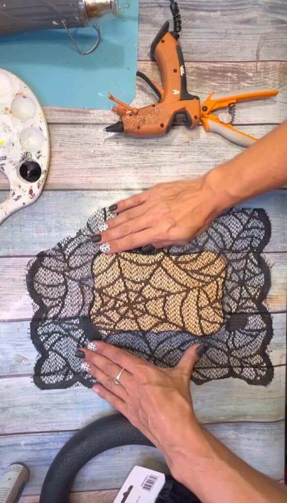 A large square of the black lace, glued to the back of the wood plaque with the witches print