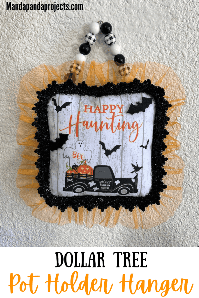 Dollar Tree Halloween Pot Holder with a Ghost, bats, and an old truck that says "Happy Haunting with orange tulle trim around the edge and a black and white buffalo check wood bead hanger, DIY doorknob hanger.