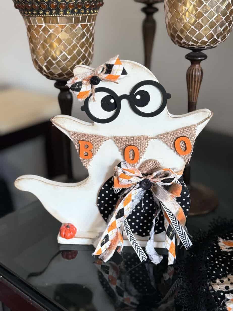 Thrifted Wood Ghost Makeover with black glasses and a burlap banner that says BOO.