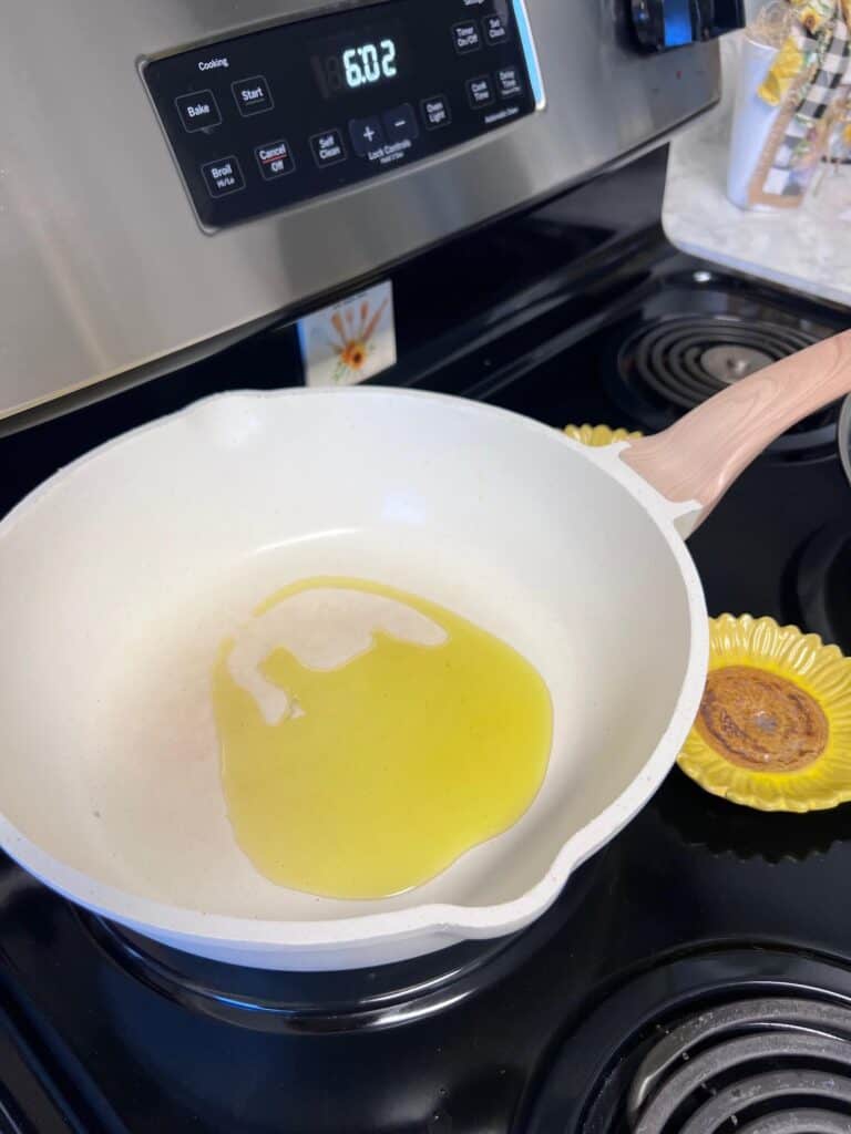 Olive oil in a large wok style pan.