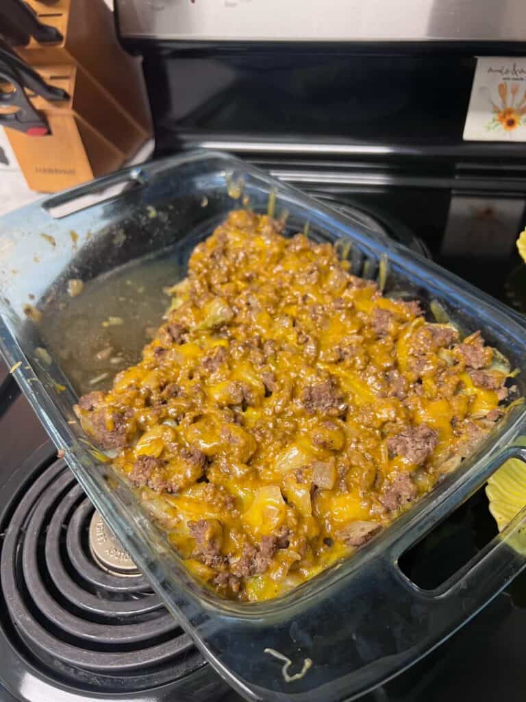 Cabbage casserole with sautéed cabbage, ground beef, onion and extra sharp cheddar cheese, layered and baked until cheese is melted and served with franks red hot sauce.