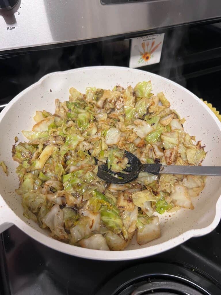 Cabbage sauteed in a wok style pan.