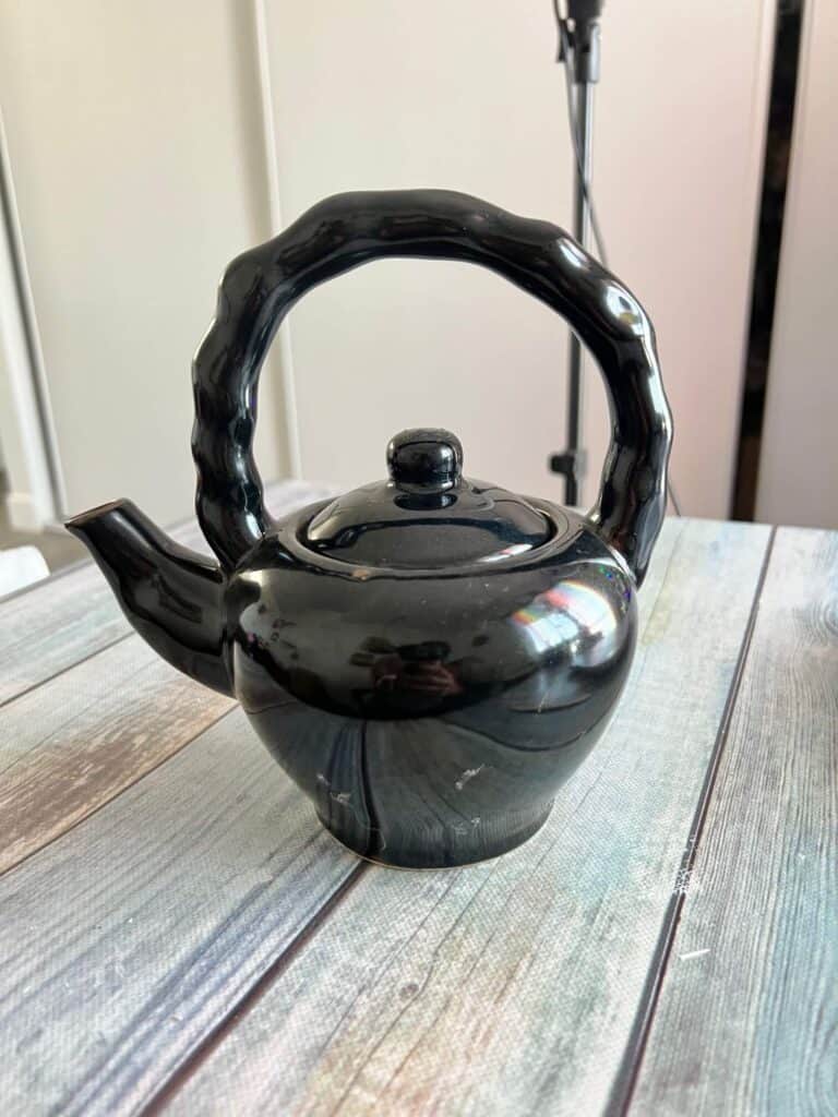 Black thrifted teapot.