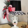 Turn and ordinary thrift store small lamp into adorable and budget friendly Christmas and Winter decor by painting it to look like a snowman. With the lampshade being the "top hat" with a cute red, black, and white bow and a jingle bell, and the lamp body painted like a snowman face.