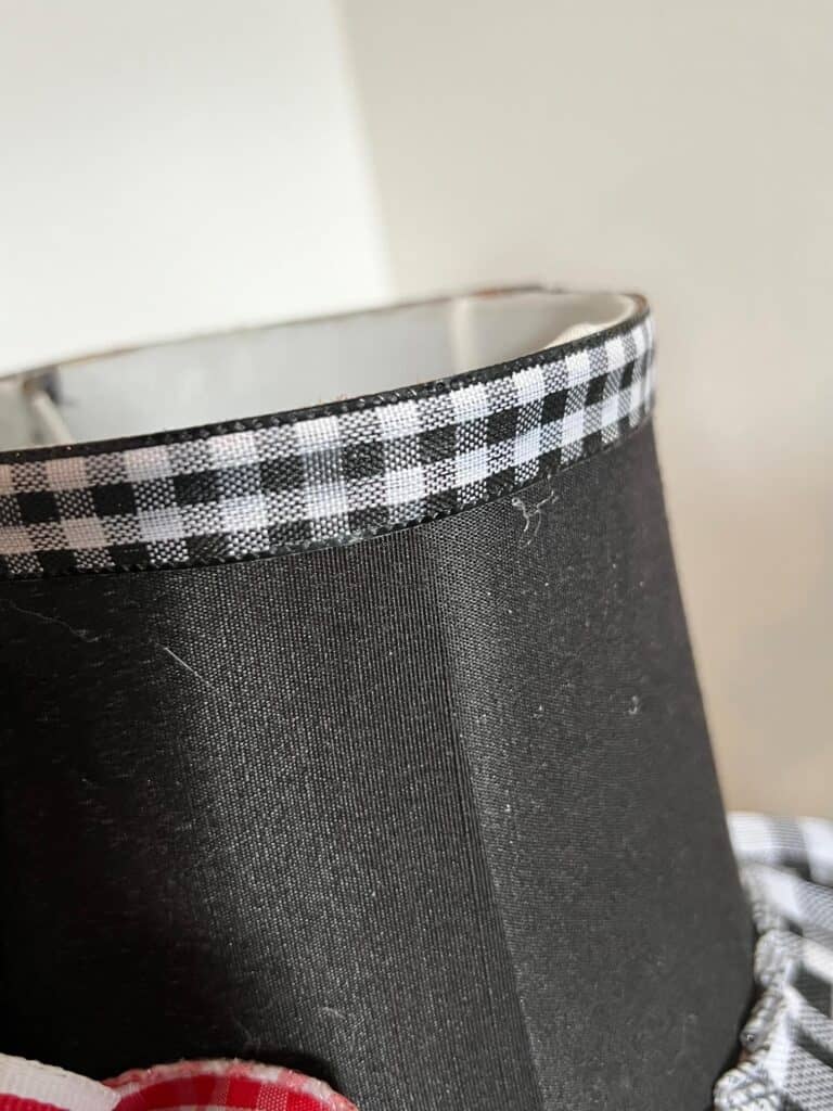 Thin buffalo check ribbon glued to the top rim of the lampshade.