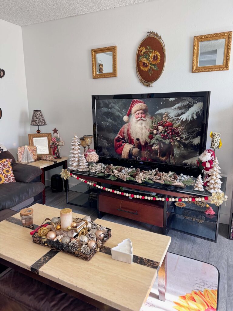 San Diego apartment living room decorated for Christmas in 2024 with vintage gold, white, and and maroon theme with santas, snowmen, christmas trees, Angels, and lots of gold!