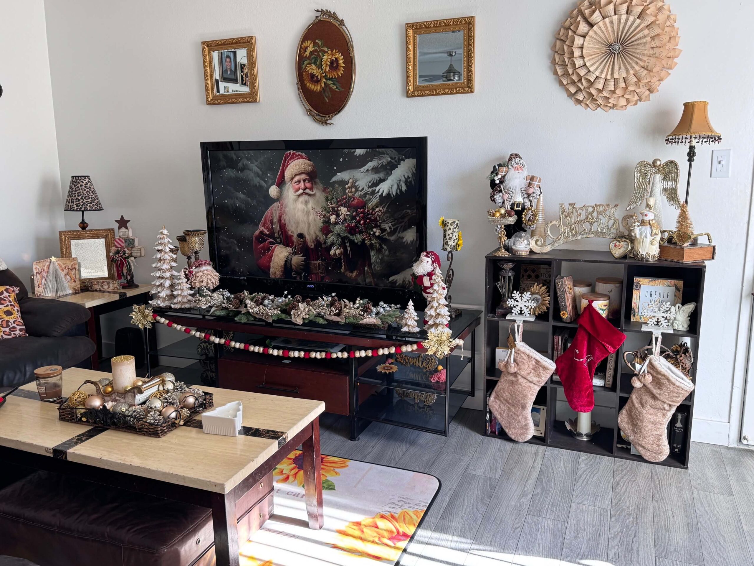 San Diego apartment living room decorated for Christmas in 2024 with vintage gold, white, and and maroon theme with santas, snowmen, christmas trees, Angels, and lots of gold!