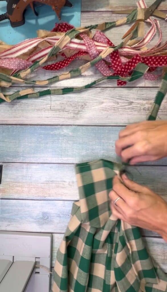 Ripping red and green fabric into long 1" strips