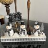 Snowmen Ornament Shelf sitter made with 3 mini felt white snowmen from walmart, on a wood base with a chalkboard sign that says "let it snow", snowballs made with white pom poms, and black and silver bottle brush christmas trees.