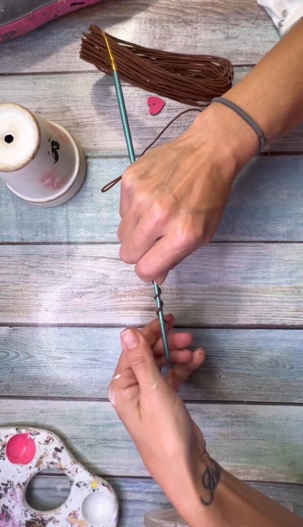 Twist the primitive wire around the end of a paintbrush.