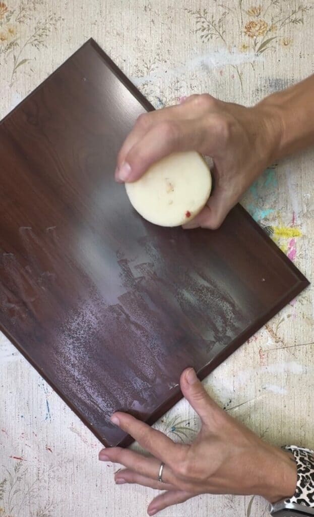 Rub candlewax onto the wood surface.