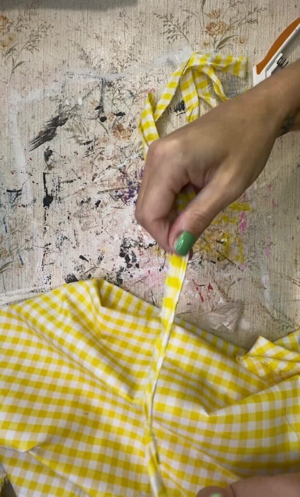 Ripping the yellow gingham fabric into strips.