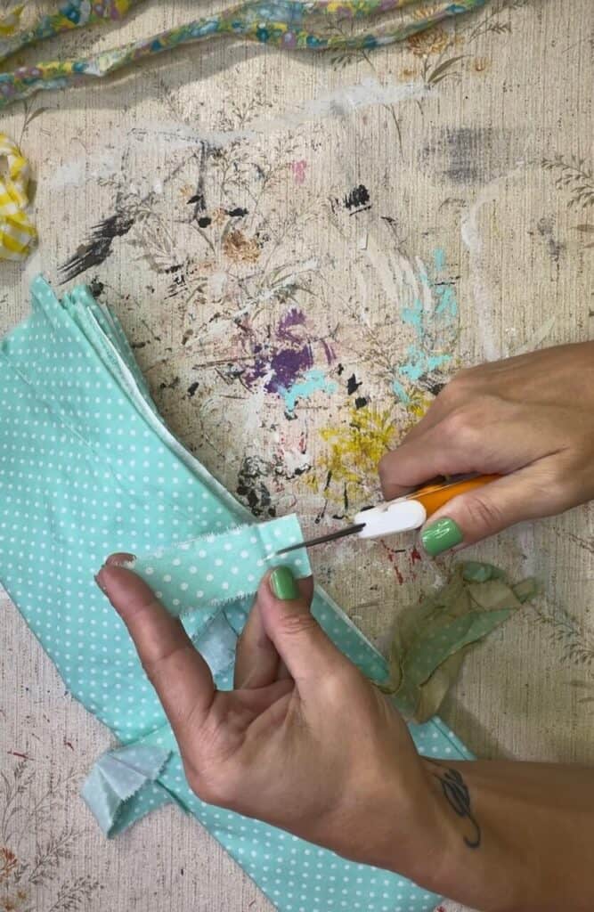 Ripping the teal polka dot fabric into strips.