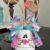 White Terra Cotta Pot Bunny with wired jute ears, a pink, purple, and teal messy fabric bow and a cute tag on her ear that says "bunny love" for spring and easter crafts and decor.