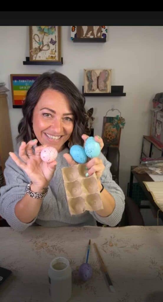 Amanda holding 3 plastic eggs and an egg carton.