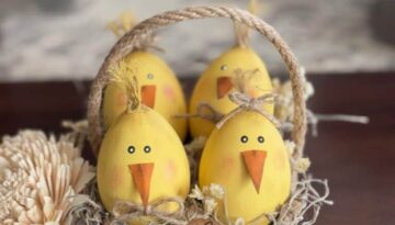 Wood easter eggs made into cute lil yellow peeps chicks in a recycled egg carton with spanish moss and a tag that says "Chicks .10 c" and a jute rope handle.