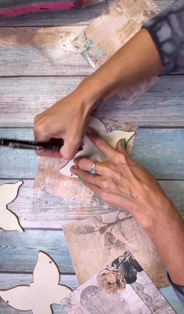 Trace the wood butterflies onto the vintage scrapbook paper.