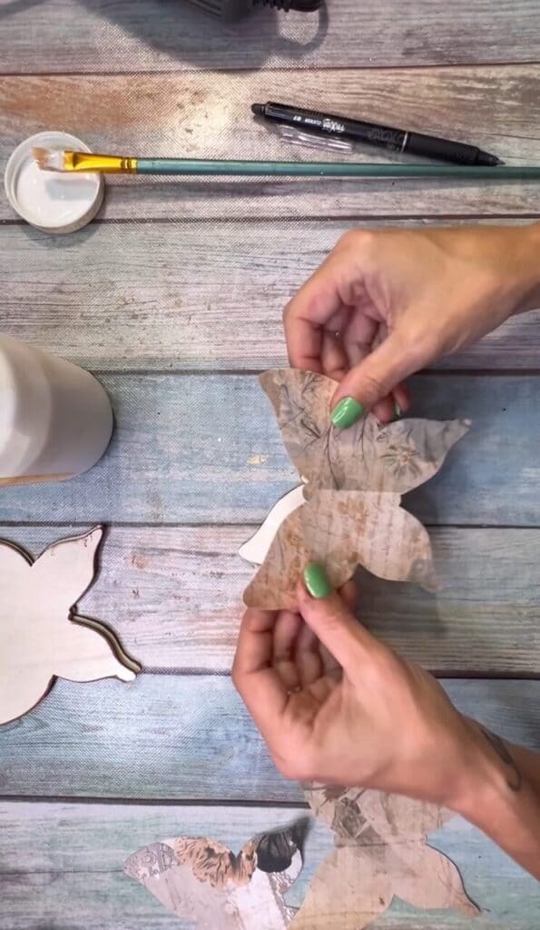 Apply the vintage scrapbook paper to the wood butterfly with mod podge decoupage method.