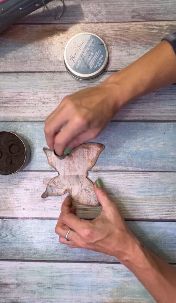 Use a finger dauber to apply Kilz Dark Wax to the outer edges of the butterfly.