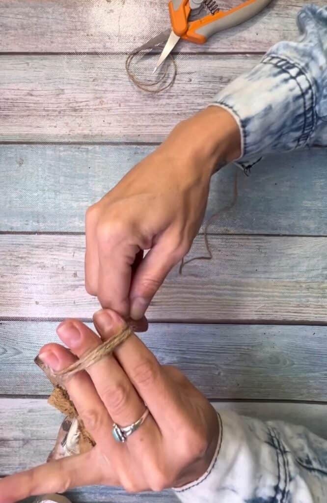 Wrap twine around your fingers to make a bow.