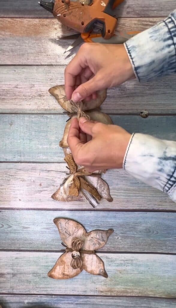 Add the twine bow to the front of  the wood butterfly.