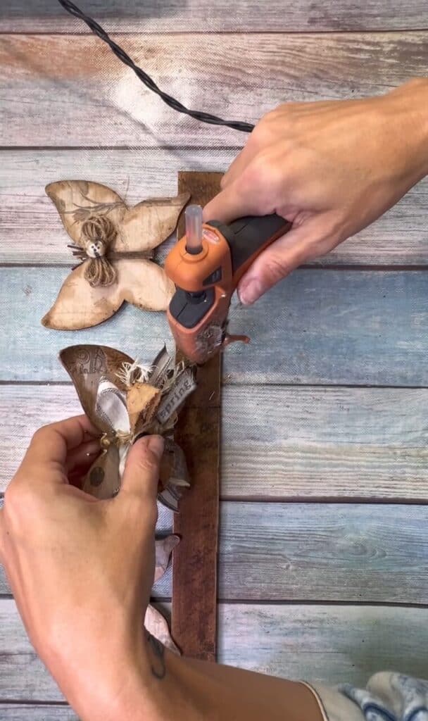 Glue the wood butterflies to the base.