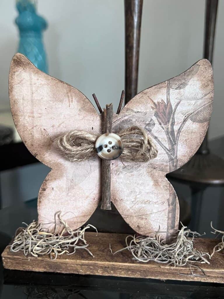 Close up of one of the wood butterflies all done with the twine bow and a button.