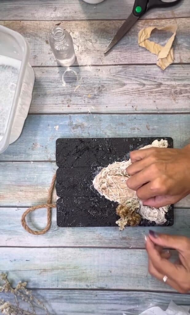 Hot glue the dried flower bouquet into the ghosts "hand".