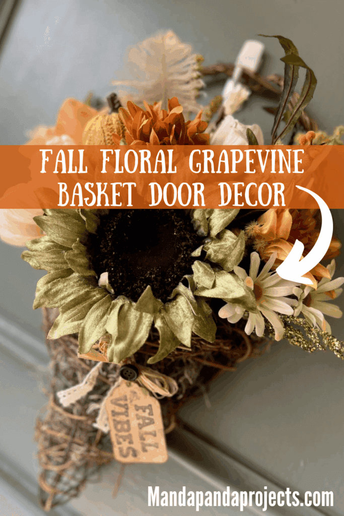 Fall floral grapevine wreath basket door decor hanging on a sage green front door with pretty fall flowers, a sweater pumpkin pick and a hangtag that says "Fall vibes".