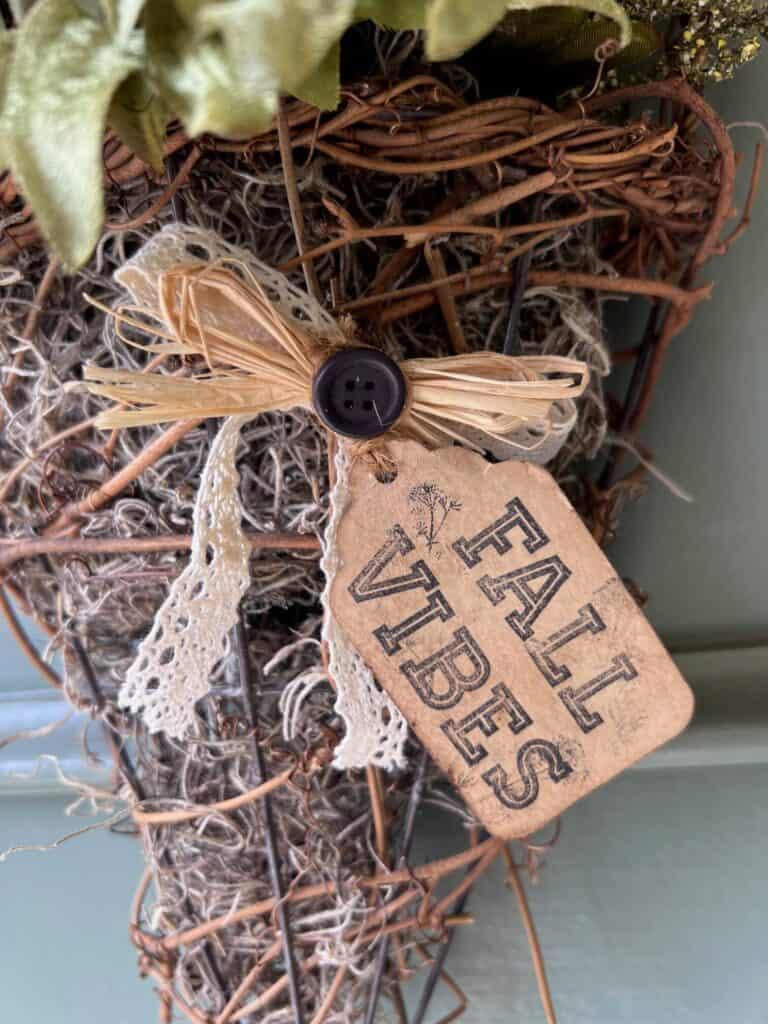 Kraft paper hangtag that says "Fall Vibes" on the front of the basket.