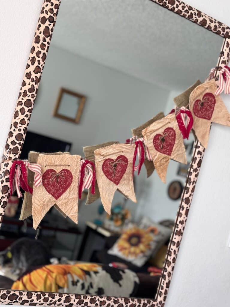 Primitive Style Valentines Day Heart Garland or banner with coffee stained muslin, deep red hearts, skeleton key embellishments and red homespun fabric DIY Decor on a mirror.