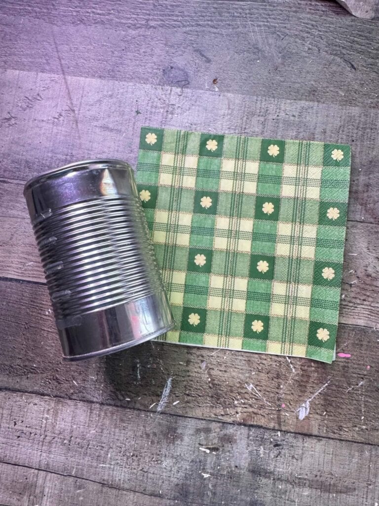 Tin can and a green and shamrock check decoupage napkin.