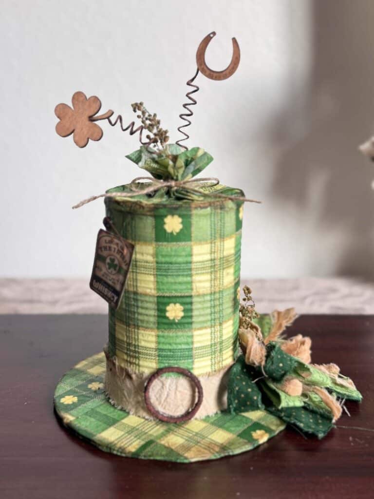 Tin Can decoupaged leprechaun hat with a St. Patricks Day check and shamrock napkin with green bow and cute tag.