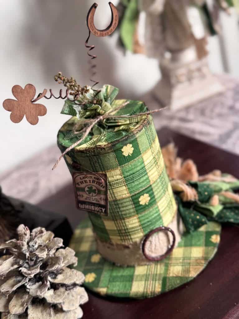 Tin Can decoupaged leprechaun hat with a St. Patricks Day check and shamrock napkin with green bow and cute tag.