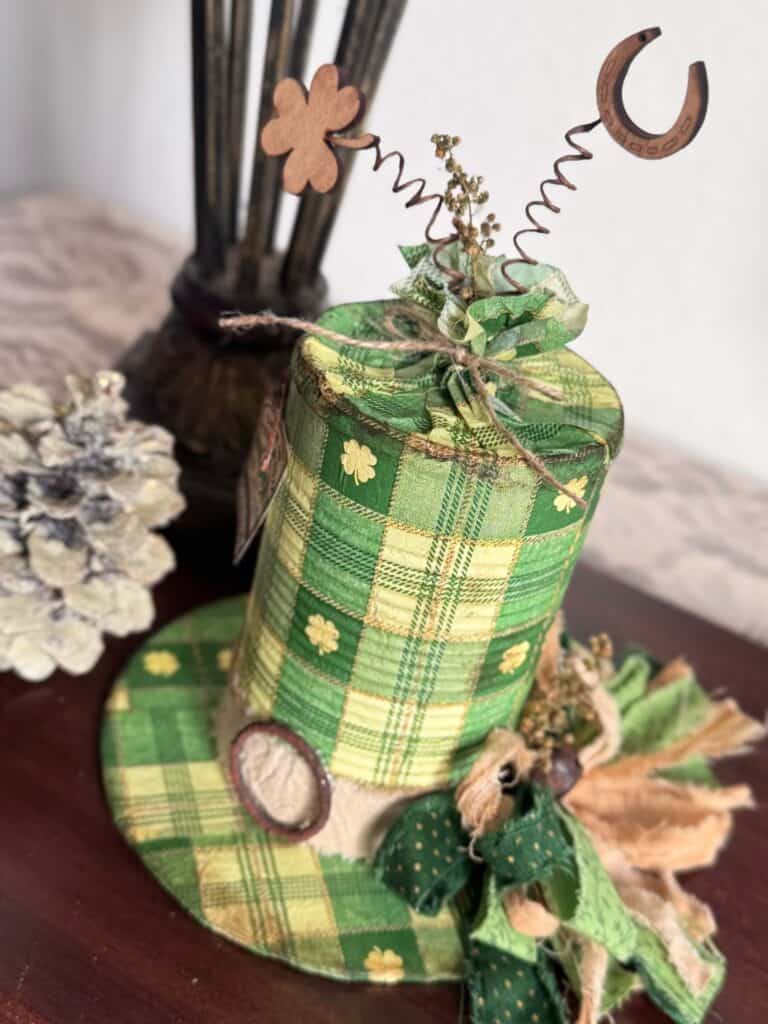 Tin Can decoupaged leprechaun hat with a St. Patricks Day check and shamrock napkin with green bow and cute tag.