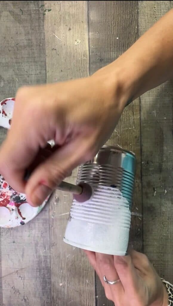 Painting the tin can all white with a spouncer