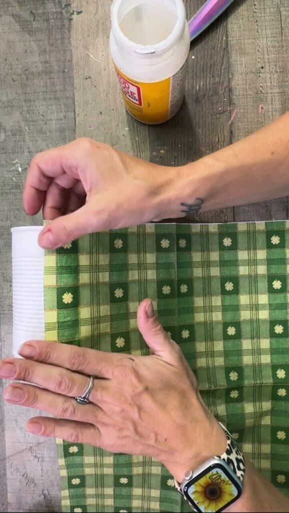 Decoupaging the green check napkin to the tin can.
