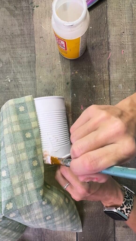 Decoupaging the green check napkin to the tin can.