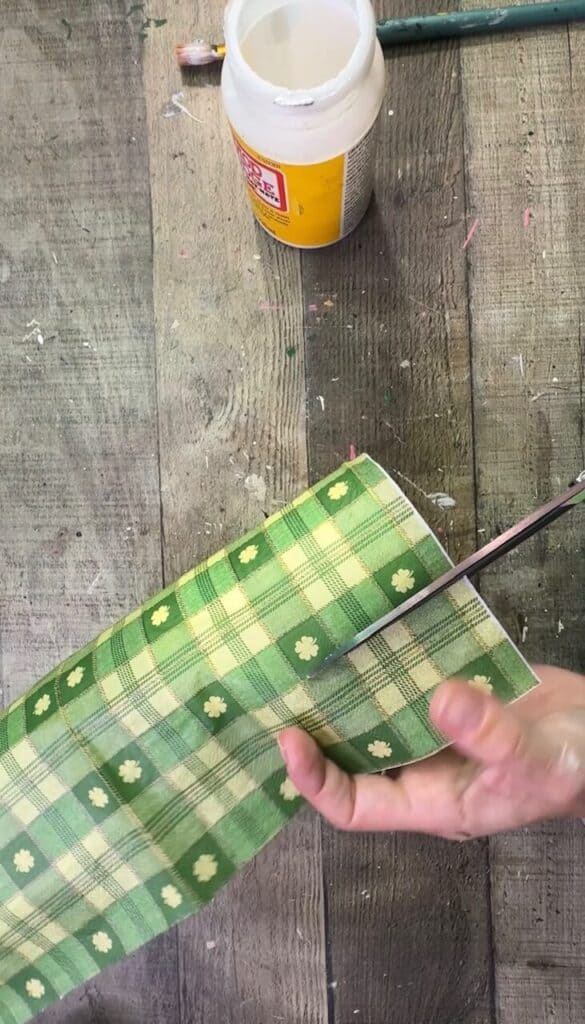 Cutting off the excess napkin from the can.