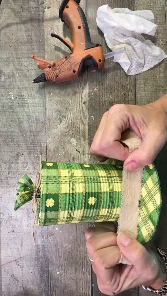 Gluing coffee stained muslin to the bottom of the hat.