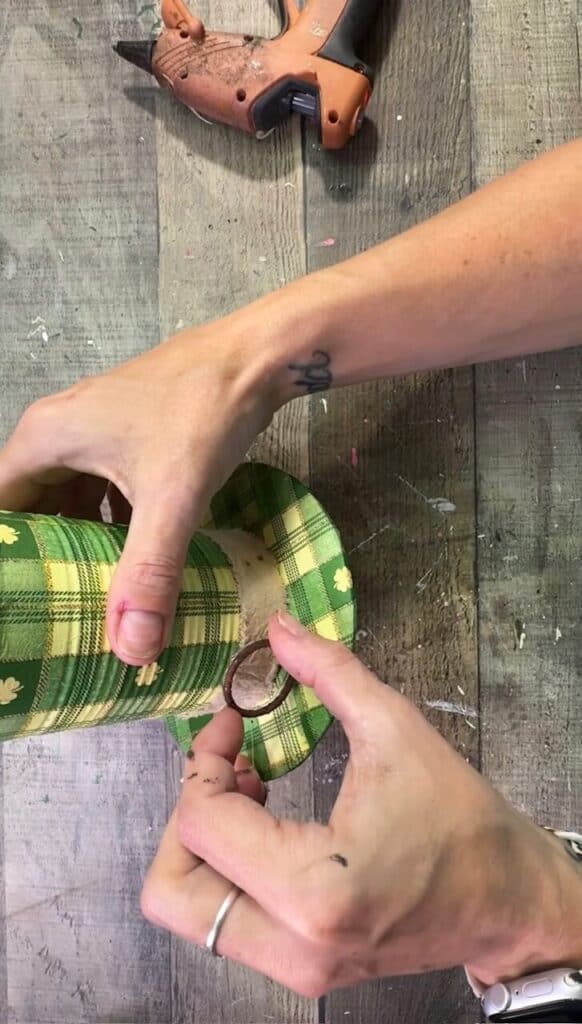 Gluing a rusty metal ring to the hat belt.
