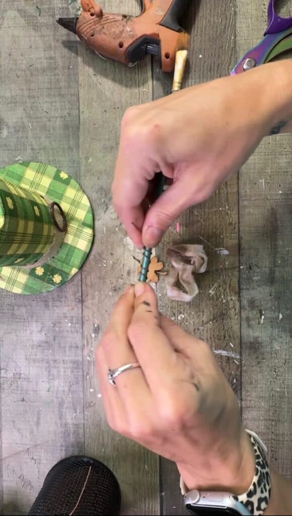 Wrapping the rustic wire around a paint brush to make a spring.