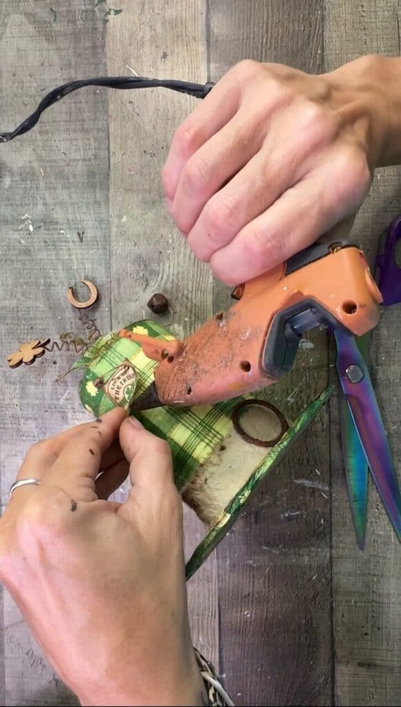 Gluing the hangtag to the side of the hat.