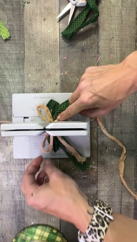 Making a bow with a bowdabra with green colors to match the hat.